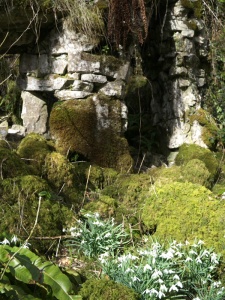 Much of the folly is now covered in vegetation and moss